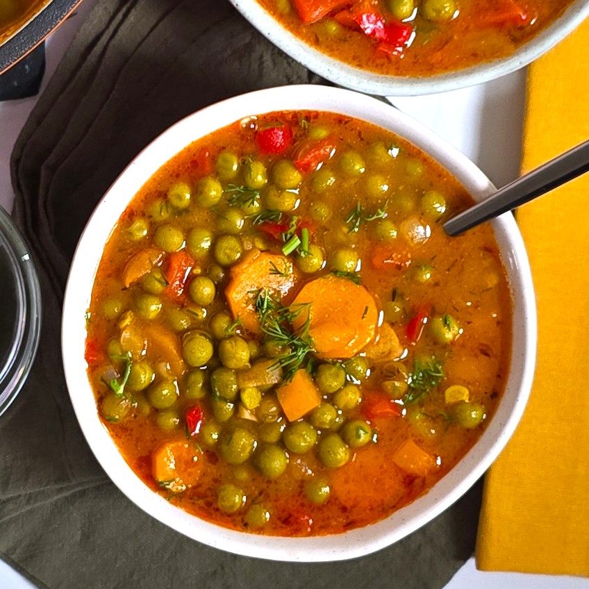 pea stew in a white rustic bowl